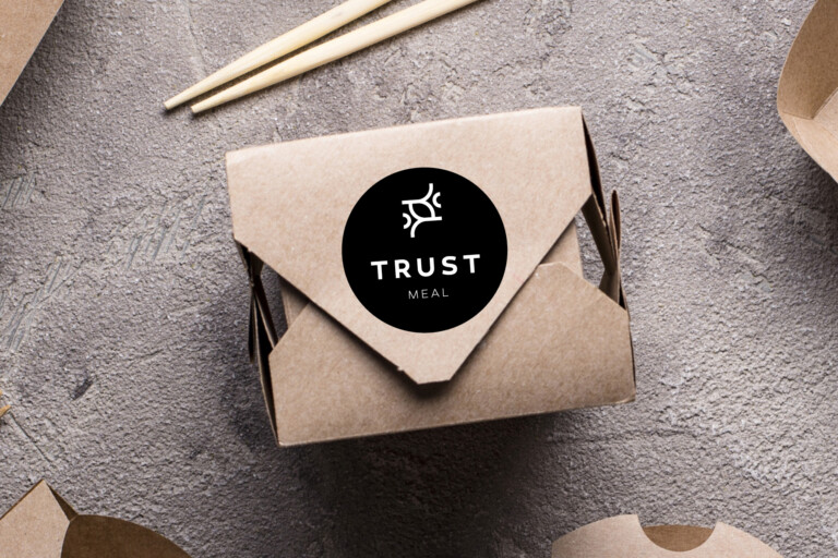 Logo for Trust Meal på en takeaway-boks